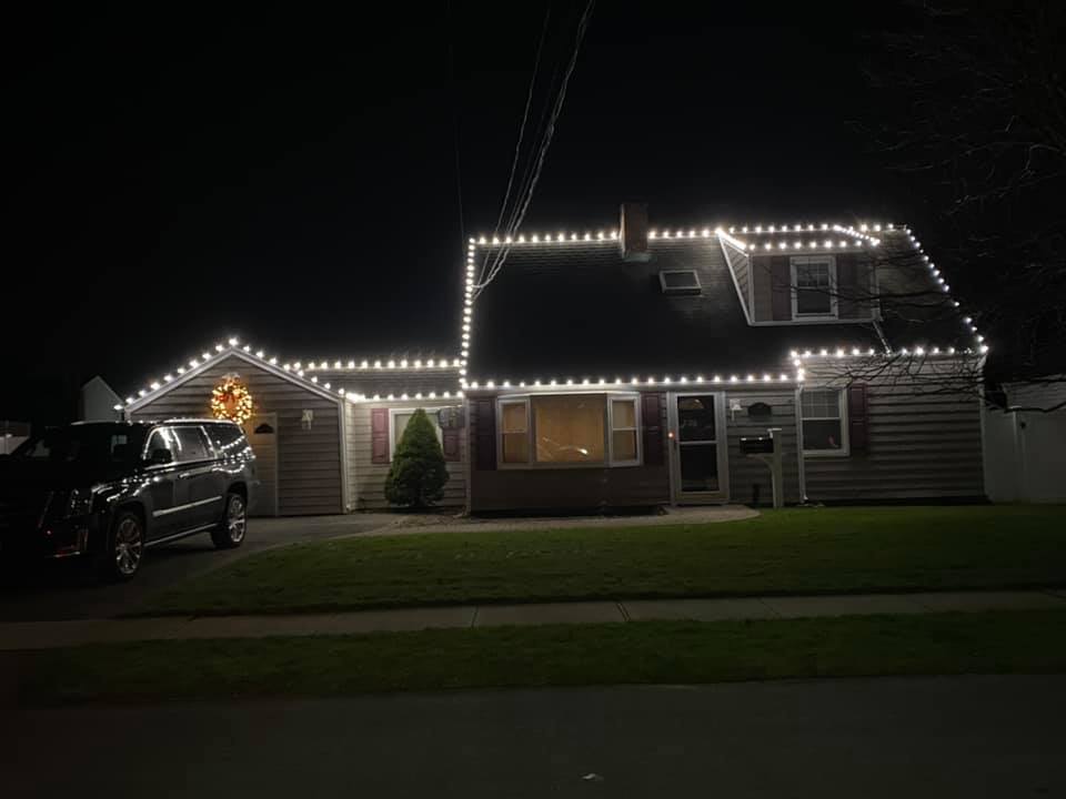 christmas lights installed on the rooflines of a house